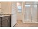Elegant bathroom showcasing granite counters, spacious shower, and wood-look floors at 15032 W Gray Fox Trl, Surprise, AZ 85387