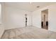 Bedroom with carpet flooring, white walls, and doorway to bathroom at 15032 W Gray Fox Trl, Surprise, AZ 85387