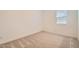Carpeted bedroom featuring neutral tones and a window with blinds for natural light at 15032 W Gray Fox Trl, Surprise, AZ 85387