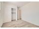This bedroom has plush carpeting, neutral walls, and a large closet at 15032 W Gray Fox Trl, Surprise, AZ 85387