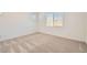 This bedroom has plush carpeting, neutral walls, and a bright window at 15032 W Gray Fox Trl, Surprise, AZ 85387