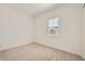 This bedroom has plush carpeting, neutral walls, and a window with blinds at 15032 W Gray Fox Trl, Surprise, AZ 85387