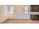 Dining area with wood-look tile floors, adjacent to kitchen with natural light at 15032 W Gray Fox Trl, Surprise, AZ 85387