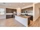Modern kitchen featuring granite countertops, stainless steel appliances, and dark wood cabinets at 15032 W Gray Fox Trl, Surprise, AZ 85387