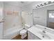 Well-lit bathroom features a shower-tub combo, a vanity with sink, and a large mirror at 15420 S 29Th St, Phoenix, AZ 85048
