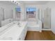 Bright bathroom with a soaking tub, double sinks, a glass-enclosed shower and view of the neighborhood at 15420 S 29Th St, Phoenix, AZ 85048