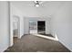 Neutral bedroom featuring a ceiling fan, carpet, and a sliding glass door at 15420 S 29Th St, Phoenix, AZ 85048