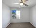 Bright bedroom with a ceiling fan and window overlooking the front yard at 15420 S 29Th St, Phoenix, AZ 85048