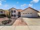 Charming home with desert landscaping, brick walkway, attached garage, and neutral colored stucco exterior under a blue sky at 15420 S 29Th St, Phoenix, AZ 85048