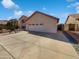 Angle view of home's facade featuring a two car garage, desert landscaping, and concrete driveway at 15420 S 29Th St, Phoenix, AZ 85048