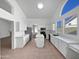 Bright kitchen features white cabinetry, a kitchen island, stainless steel appliances, and tile floors at 15420 S 29Th St, Phoenix, AZ 85048