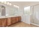 Bathroom boasts a double vanity, walk-in tub, tiled floor, and a glass shower enclosure at 15576 W Yucatan Dr, Surprise, AZ 85379