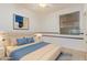 Comfortable bedroom with a plush bed, blue accents, and natural light through the window at 15576 W Yucatan Dr, Surprise, AZ 85379