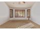 Bedroom featuring carpeted floors, bright white walls, custom window frames, and a ceiling fan at 15576 W Yucatan Dr, Surprise, AZ 85379