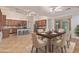 Elegant dining room with a large wooden table, seating for six, and views of the well-equipped kitchen at 15576 W Yucatan Dr, Surprise, AZ 85379