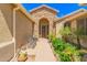 Beautiful stone entryway with desert landscaping and a cozy seating area at 15576 W Yucatan Dr, Surprise, AZ 85379