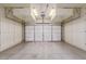 Clean, well-lit garage with built-in storage cabinets along the walls at 15576 W Yucatan Dr, Surprise, AZ 85379