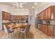 Bright kitchen features wooden cabinets, stainless steel appliances, and a breakfast table with modern chairs at 15576 W Yucatan Dr, Surprise, AZ 85379