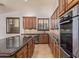 Modern kitchen with stainless steel appliances, granite countertops, and custom cabinetry at 15576 W Yucatan Dr, Surprise, AZ 85379