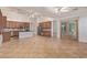 Open-concept kitchen with stainless steel appliances, wooden cabinets, tile floors and ceiling fans at 15576 W Yucatan Dr, Surprise, AZ 85379
