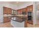 Spacious kitchen features custom wood cabinetry, granite counters, and stainless appliances at 15576 W Yucatan Dr, Surprise, AZ 85379