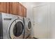 Laundry room features a modern washer and dryer and ample storage space at 15576 W Yucatan Dr, Surprise, AZ 85379