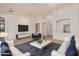 Open living room area with plush sofas, a coffee table, and large windows to let in natural light at 15576 W Yucatan Dr, Surprise, AZ 85379