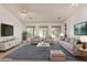 Bright living room with a neutral palette, plush seating, and views of the outdoors at 15576 W Yucatan Dr, Surprise, AZ 85379