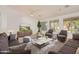 Spacious living room with contemporary furniture, a large rug, and access to backyard views at 15576 W Yucatan Dr, Surprise, AZ 85379