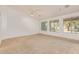 Bright living room with carpet flooring and scenic backyard views at 15576 W Yucatan Dr, Surprise, AZ 85379