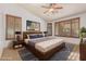 Cozy bedroom featuring a wooden platform bed, natural light, and stylish wooden window shutters at 15576 W Yucatan Dr, Surprise, AZ 85379