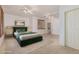 Spacious bedroom featuring an elegant green bed frame, white walls, and plantation shutters at 15576 W Yucatan Dr, Surprise, AZ 85379