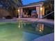 Inviting backyard pool and spa with an entertainment space featuring a covered patio with a TV at 15576 W Yucatan Dr, Surprise, AZ 85379