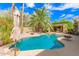 Stunning backyard pool featuring a covered outdoor living space, providing shade and relaxation by the water at 15576 W Yucatan Dr, Surprise, AZ 85379