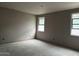 Bright bedroom featuring two windows, unfinished walls, and blank canvas for your dream design at 15768 W Beryl Ave, Waddell, AZ 85355