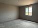 Unfinished bedroom with natural light from a window and concrete floors, ready for customization at 15768 W Beryl Ave, Waddell, AZ 85355