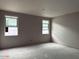 Bedroom featuring dual windows that promise ample light, awaiting your personal touch to transform this blank space at 15768 W Beryl Ave, Waddell, AZ 85355
