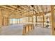 Framing view of home's interior showcasing a spacious layout, large windows, and the beginning stages of construction at 15768 W Beryl Ave, Waddell, AZ 85355