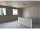 Spacious living area showcasing windows and under-construction drywall, highlighting a flexible design for customization at 15768 W Beryl Ave, Waddell, AZ 85355