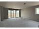 Open-concept living room with unfinished walls, large sliding glass doors, and windows offering future natural light at 15768 W Beryl Ave, Waddell, AZ 85355
