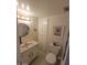 Cozy half bathroom featuring a toilet, sink, mirror, and storage at 1652 W Campbell Ave, Phoenix, AZ 85015