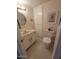 Cozy half bathroom featuring a toilet, sink, mirror, and storage at 1652 W Campbell Ave, Phoenix, AZ 85015
