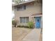 Charming two-story brick home with a blue front door and well maintained front yard at 1652 W Campbell Ave, Phoenix, AZ 85015