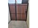 A wood and metal gate with vertical slats and a metal frame, ensuring privacy and security at 1652 W Campbell Ave, Phoenix, AZ 85015