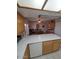 Open-concept kitchen with white countertops and wood cabinetry, adjoining a dining area at 1652 W Campbell Ave, Phoenix, AZ 85015