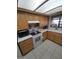 Well-lit kitchen with white countertops, tile floors, and wood cabinets at 1652 W Campbell Ave, Phoenix, AZ 85015
