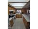 Bright kitchen featuring tile floors, wood cabinetry, and ample counter space at 1652 W Campbell Ave, Phoenix, AZ 85015