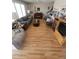 Open-concept living room with hardwood floors, large windows, and comfortable seating at 1652 W Campbell Ave, Phoenix, AZ 85015