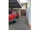 Carport featuring a red SUV and a view of the home's exterior, located next to a gated entryway at 1652 W Campbell Ave, Phoenix, AZ 85015