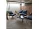 Comfortable patio setting with plush cushioned seating, an outdoor table, and a view of the backyard at 1652 W Campbell Ave, Phoenix, AZ 85015
